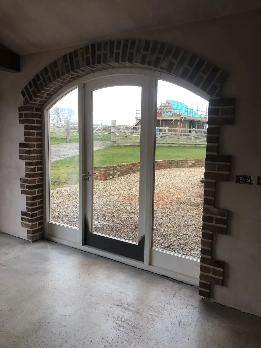 Arched glazed door in a stone barn
