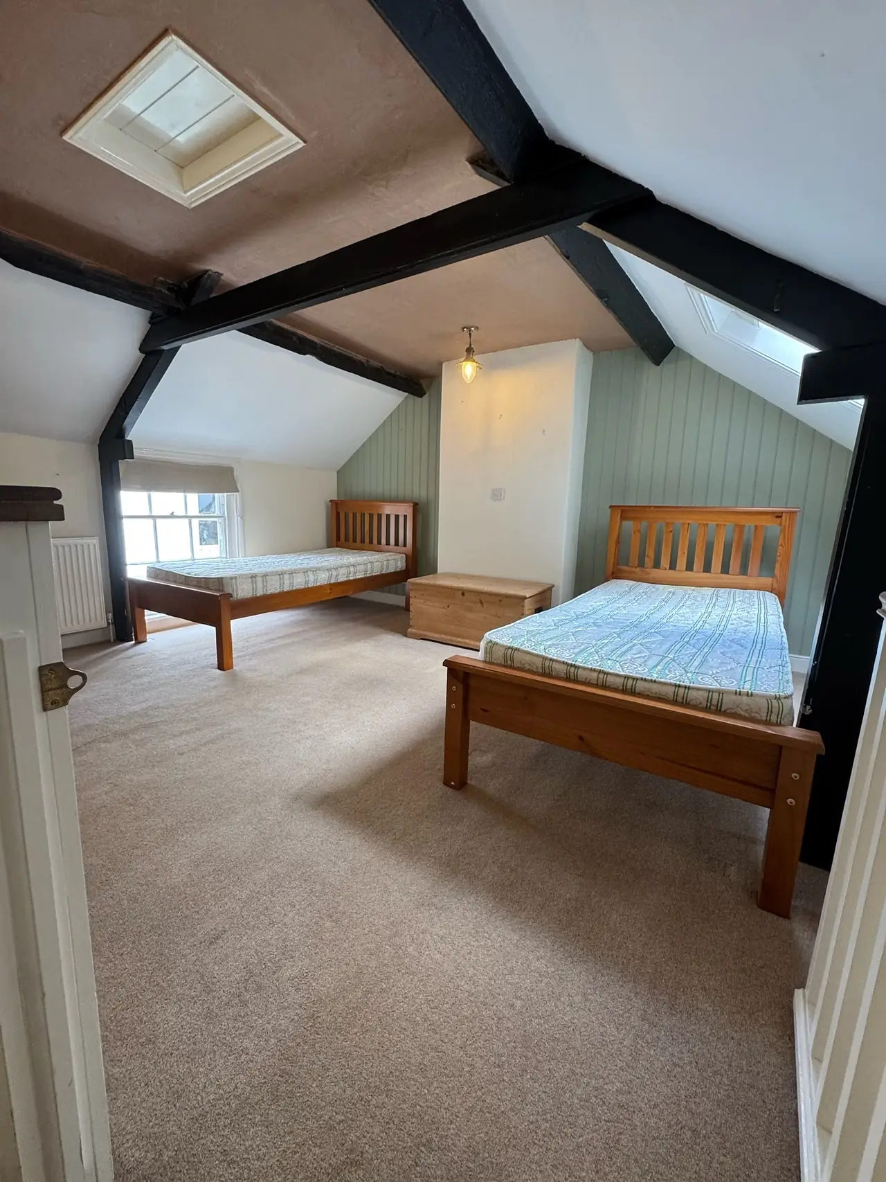 Attic bedroom plastered under exposed beams
