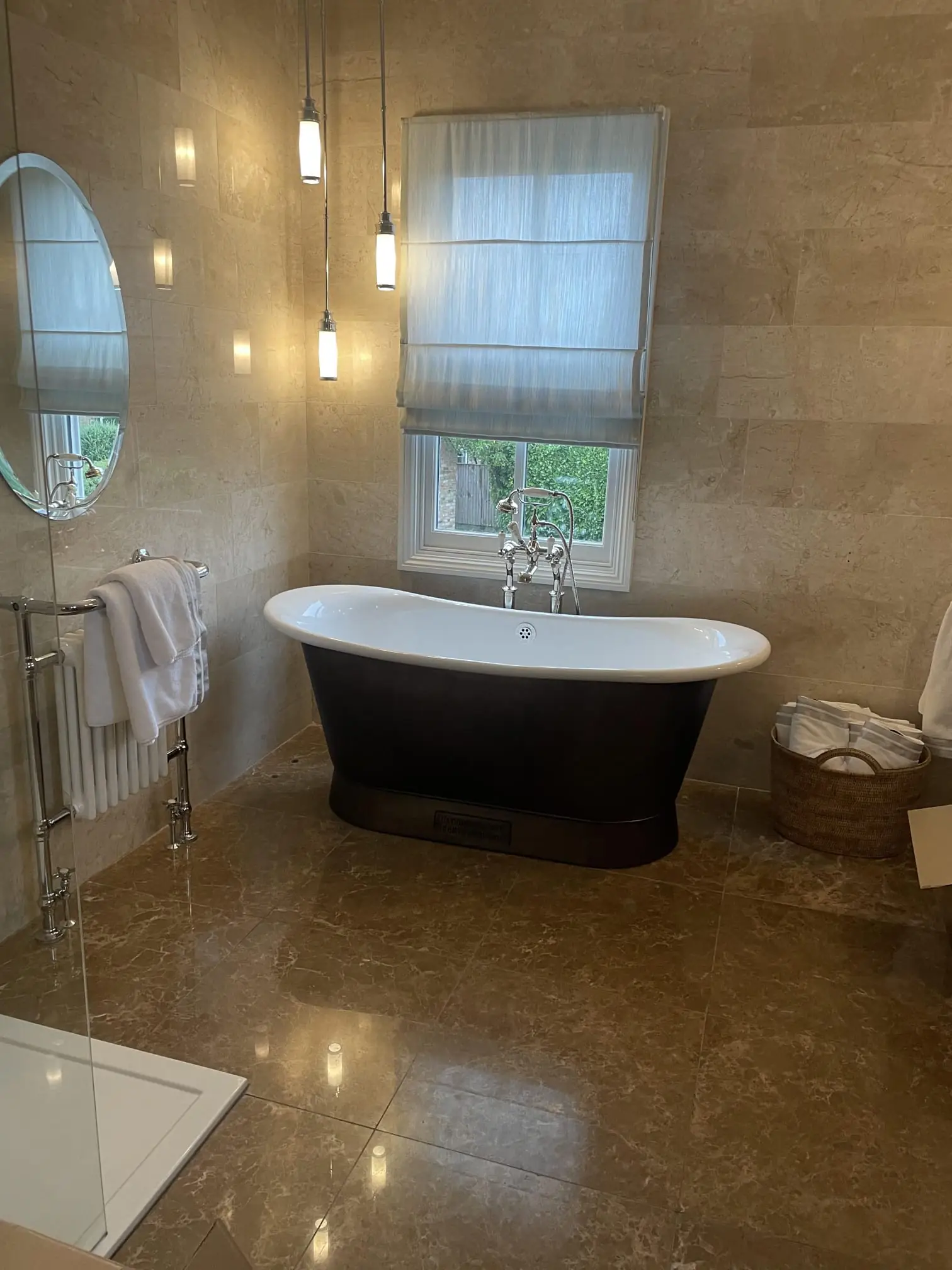 Bathroom with patterned floor and wall tiles and wood panelling