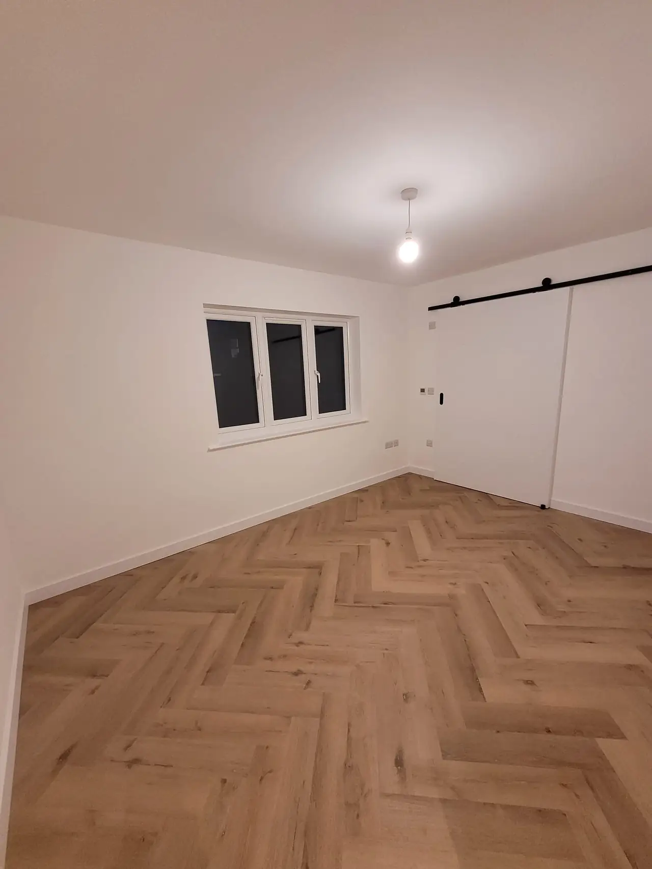 Bedroom with a herringbone floor