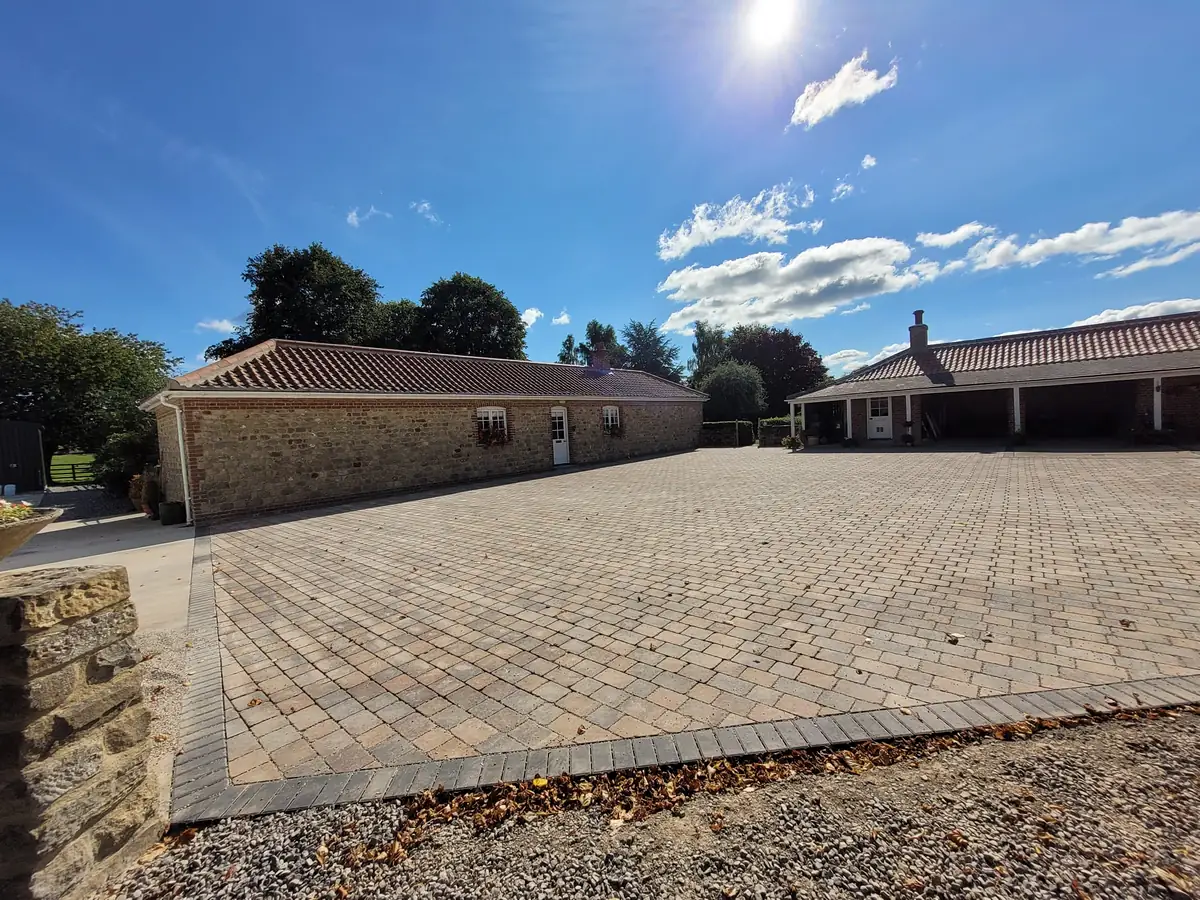 Block paved courtyard in front of a bungalow