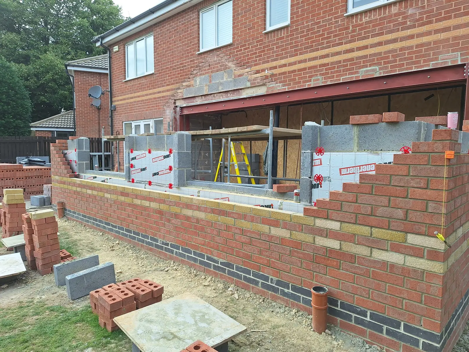 Brick and block walls up to roof level