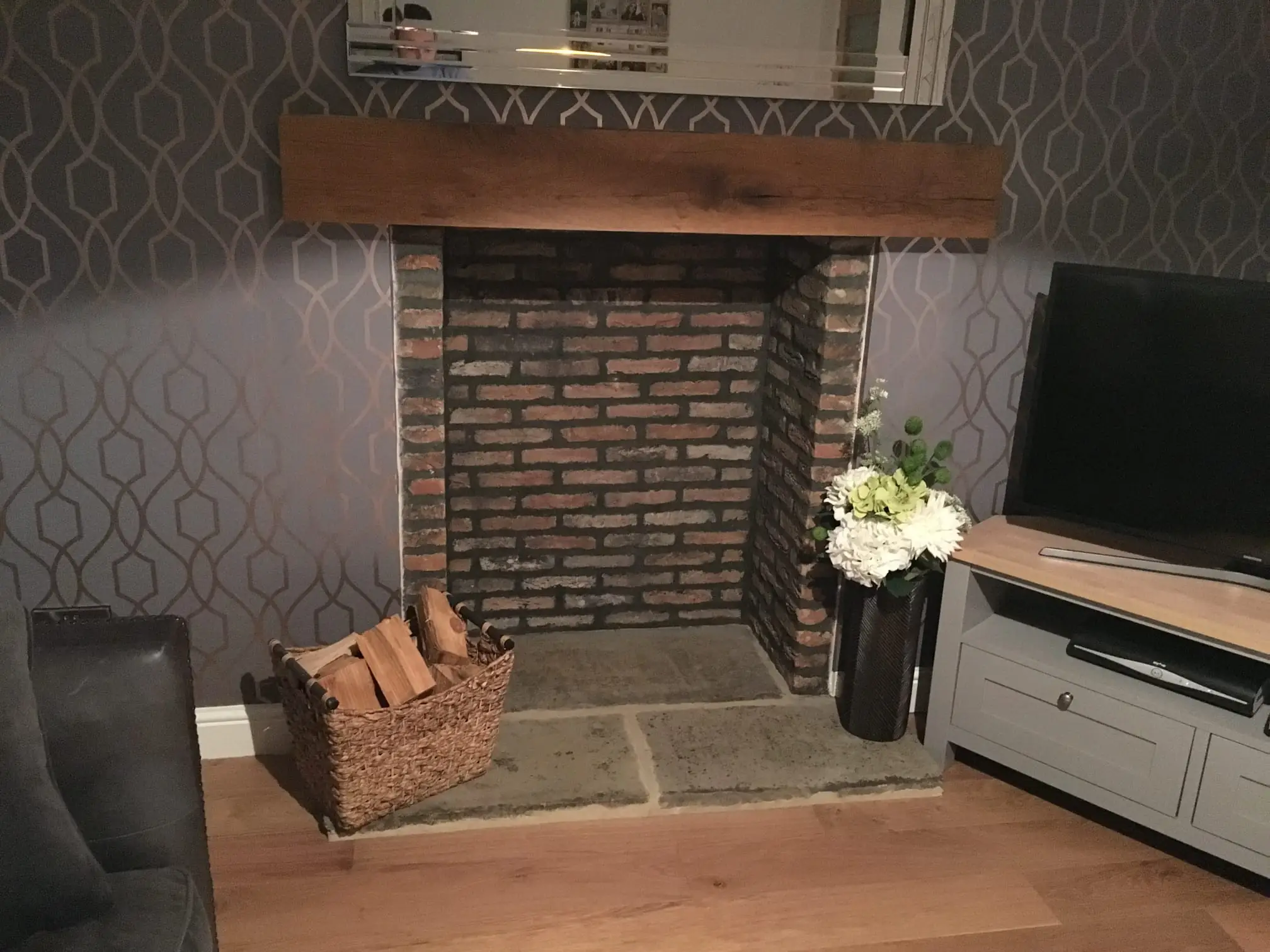 Brick fireplace with an oak beam