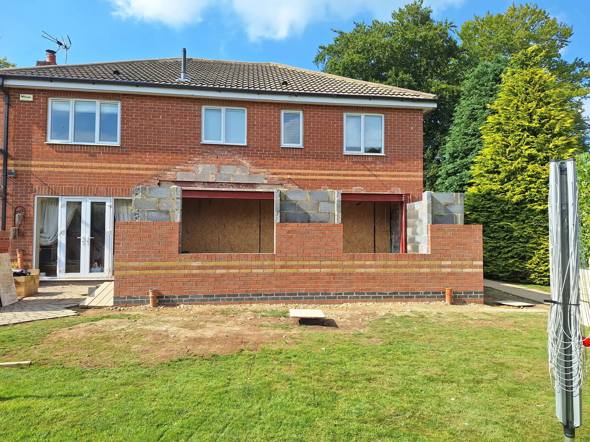 Brick outer skin rising across the back of the house