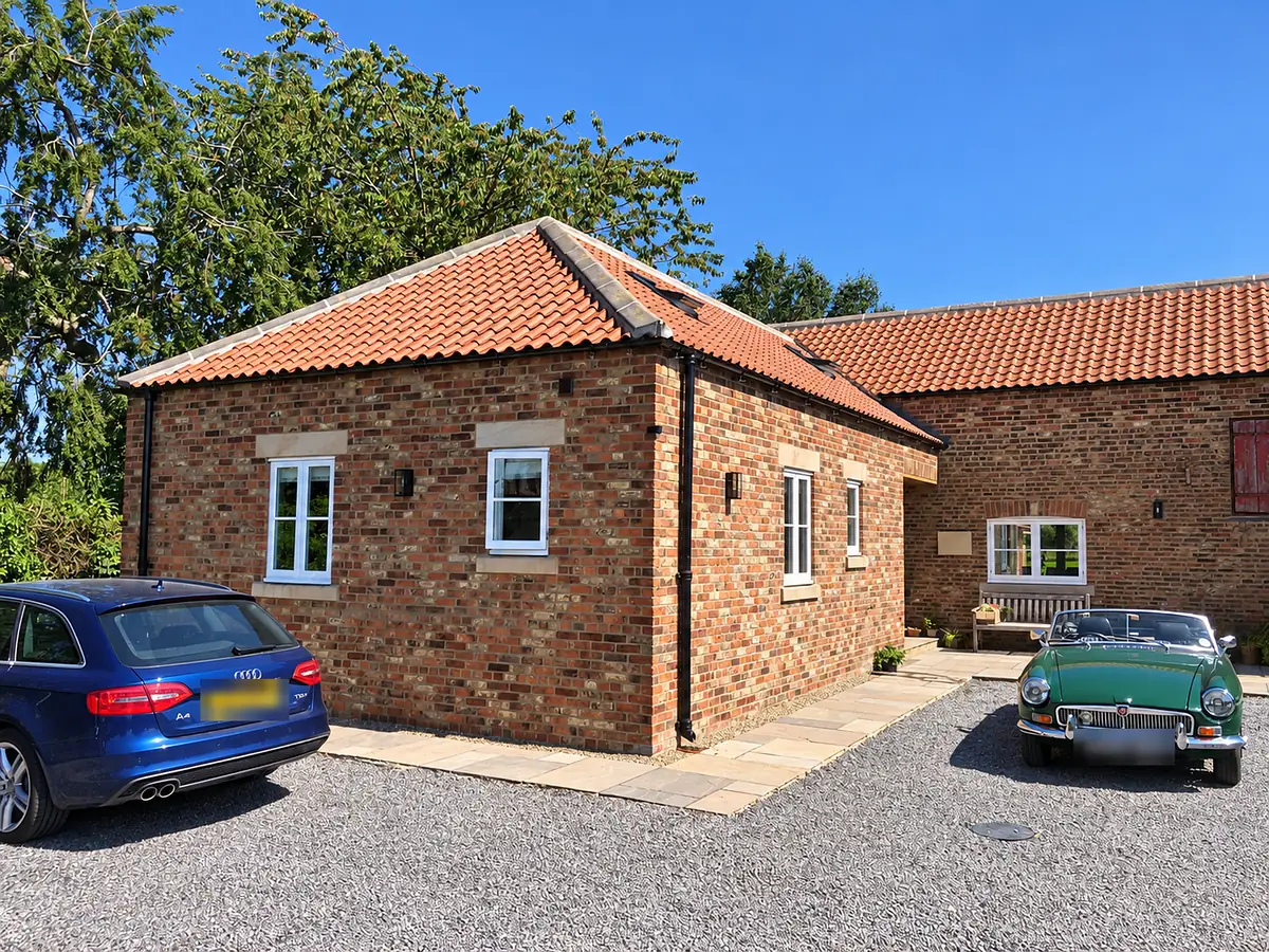 Converted brick barn with a pantile roof