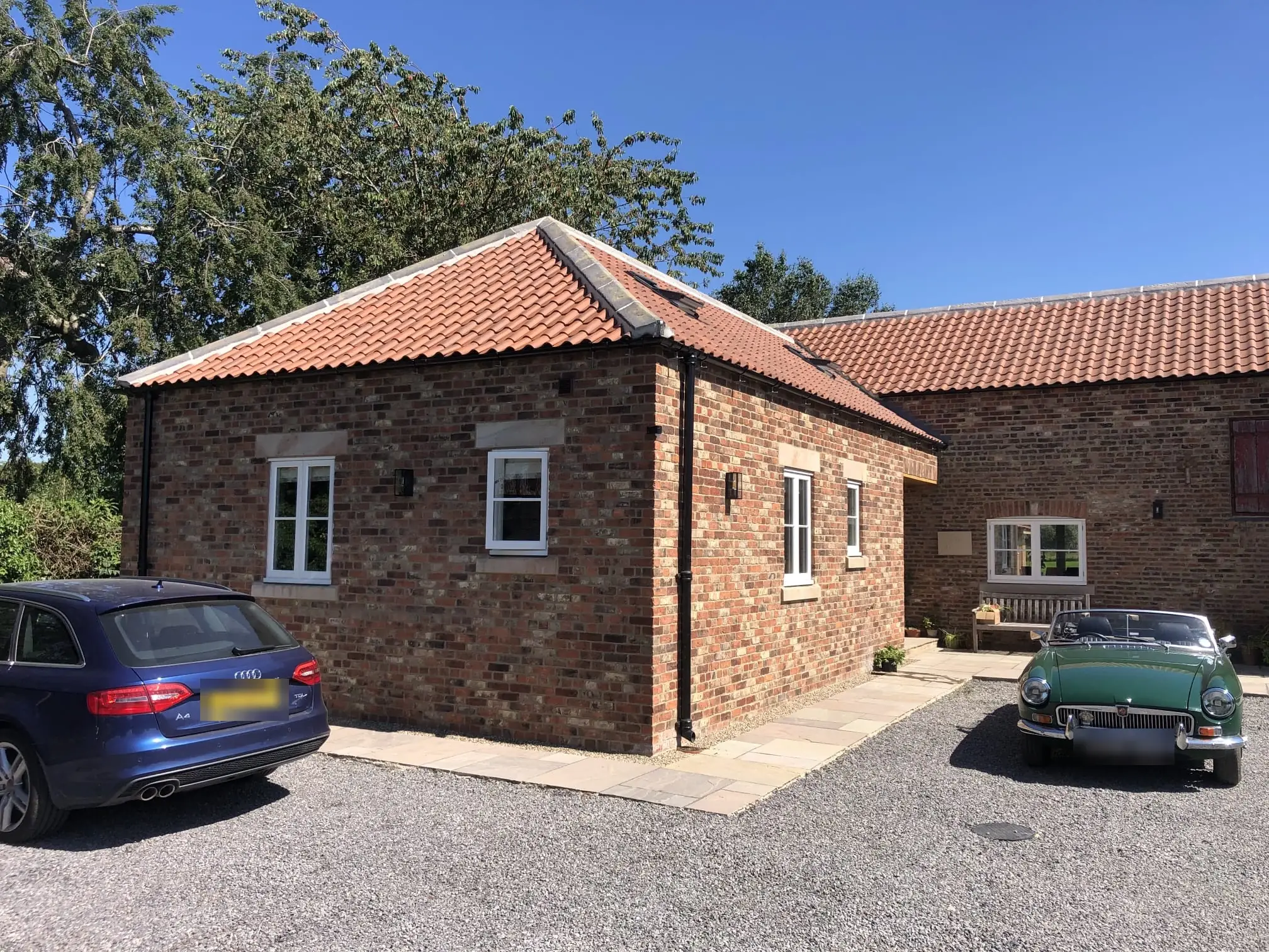 Converted brick barn with pantile roof