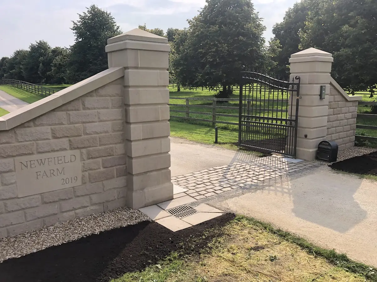 Dressed stone gate piers and wall on a country estate