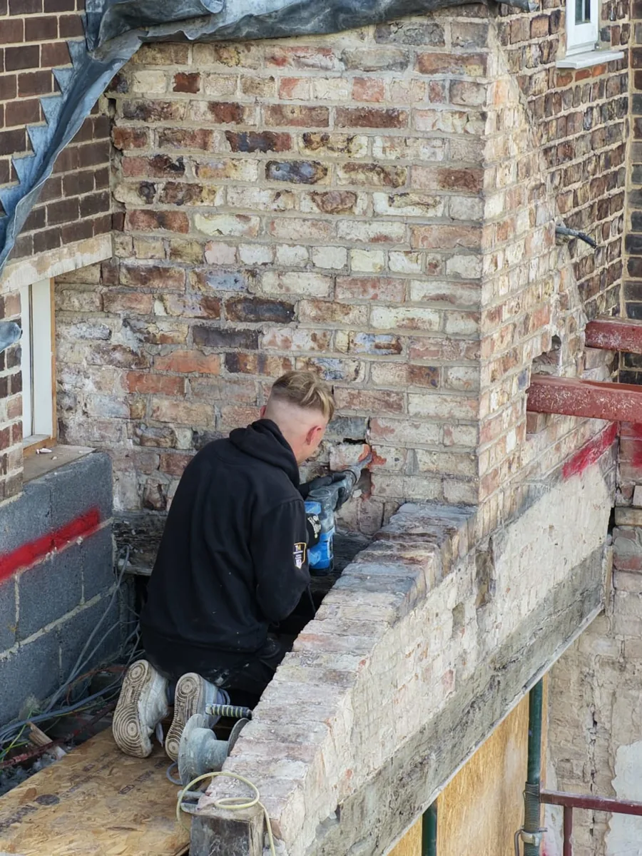 Drone close up of the brickwork where a new extension meets the old house