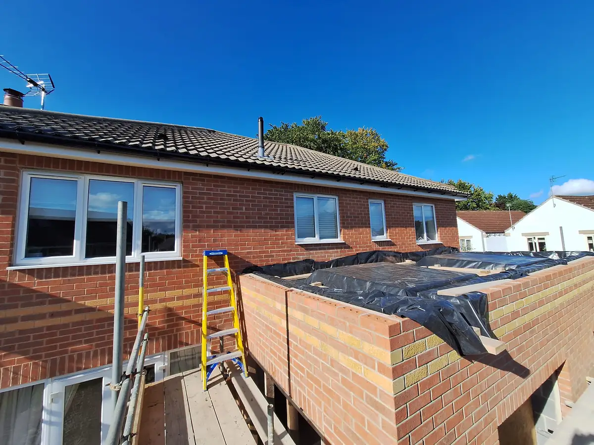 Extension walls finished at roof level with the membrane on