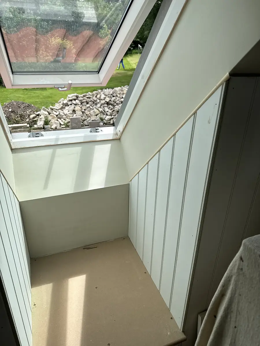 Finished loft room with panelling under a rooflight