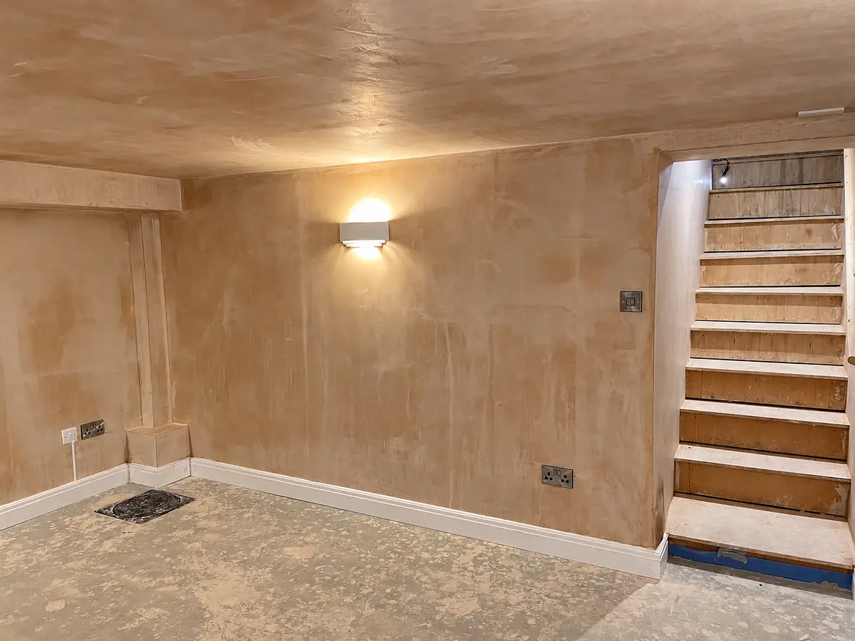 Finished plastered room with a timber staircase