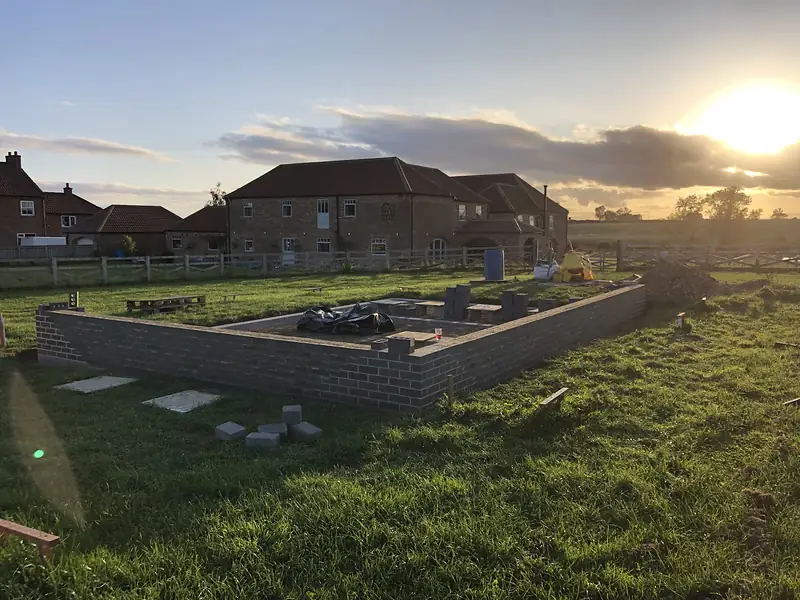 Foundations and walls rising on a new build