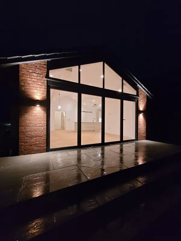 Glazed gable at Mallorie Court lit at night