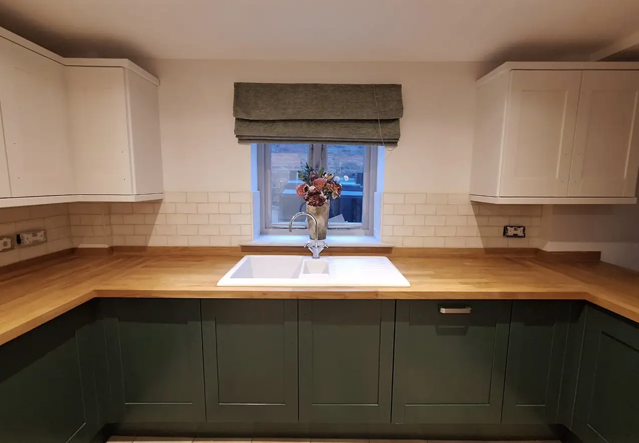 Green shaker kitchen with oak worktops