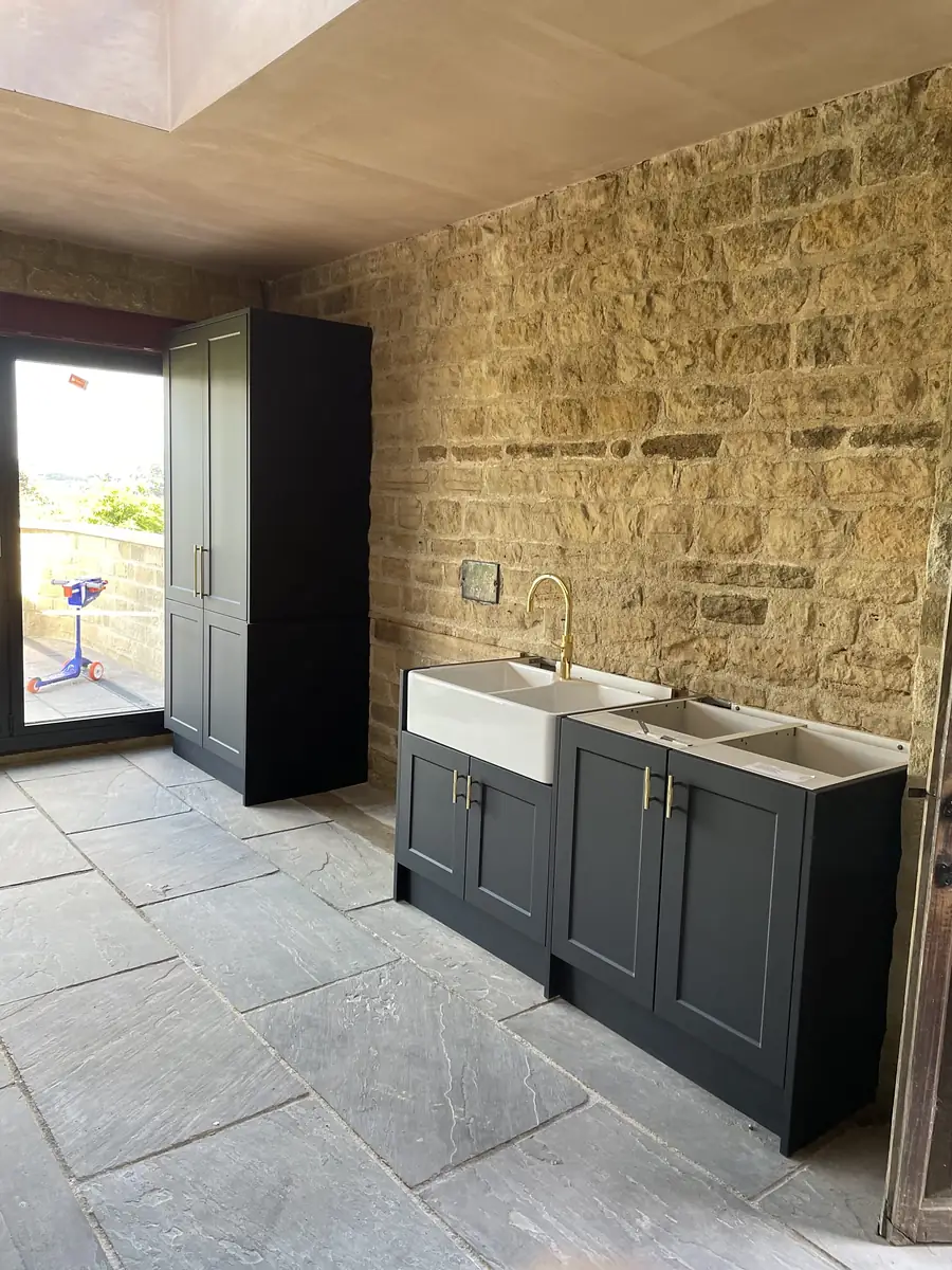 Kitchen against an exposed stone wall