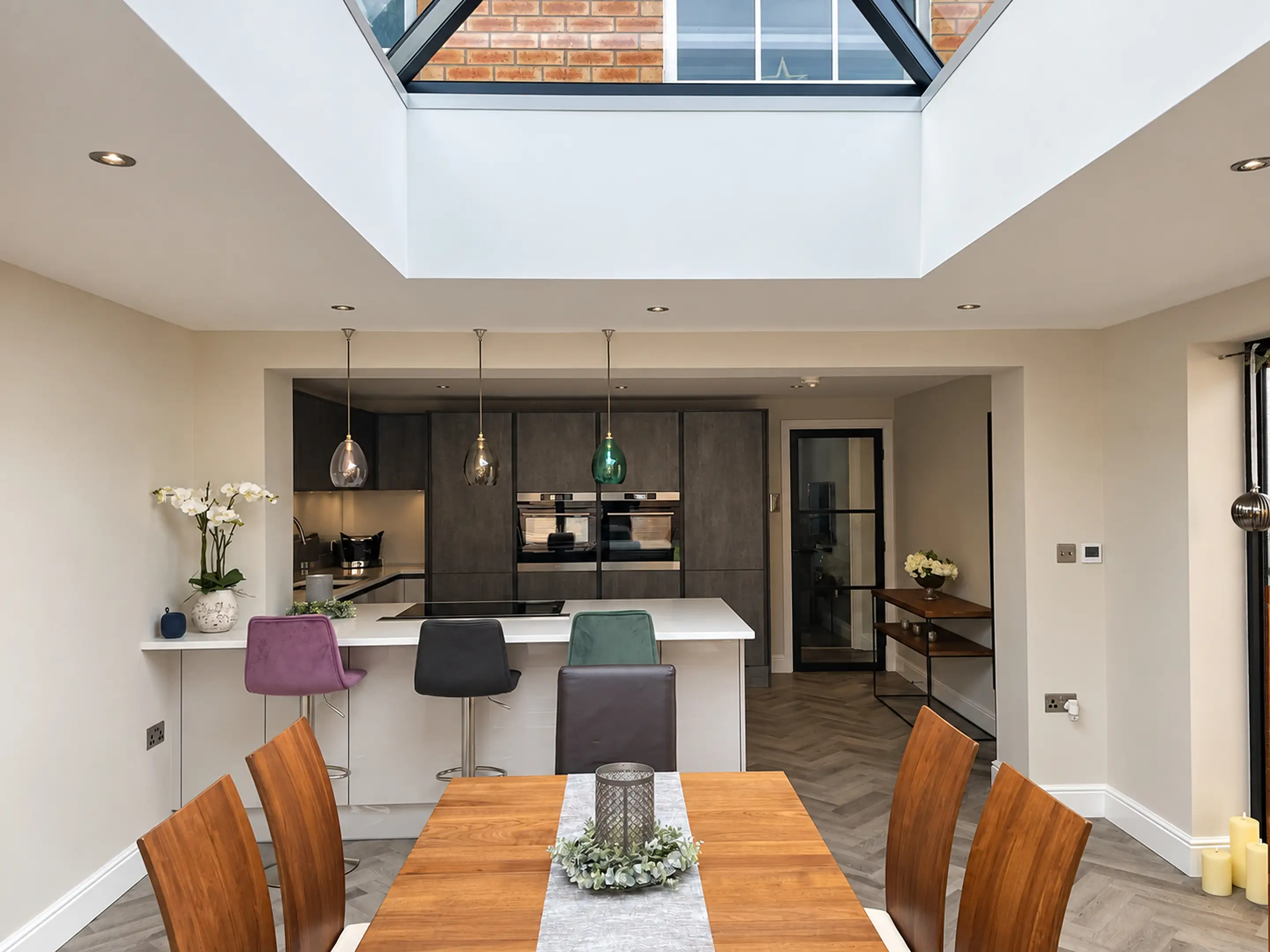 Kitchen diner under a roof lantern in a new extension