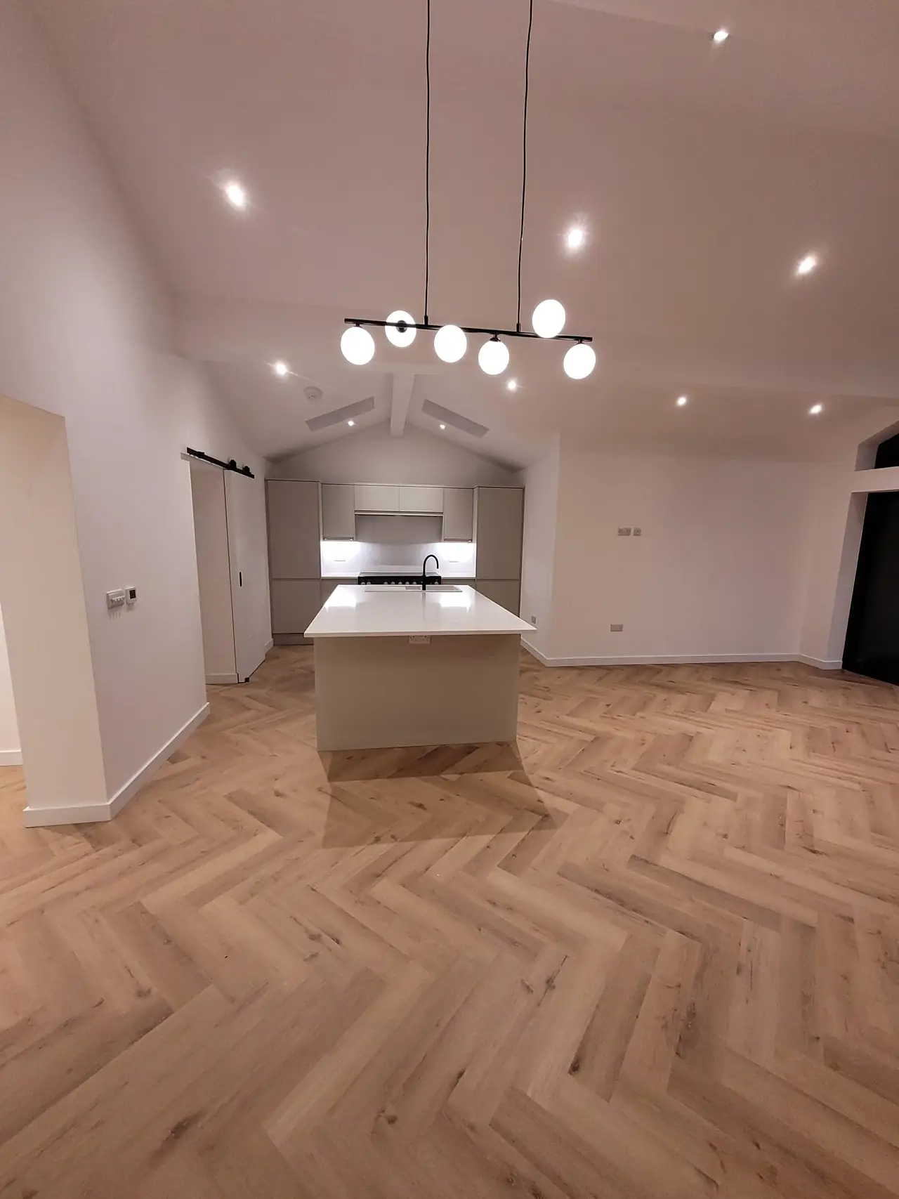 Kitchen with pendant lights under the vaulted ceiling