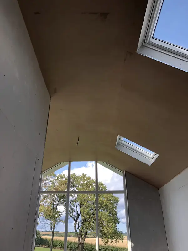 Loft room with an arched gable window and rooflight