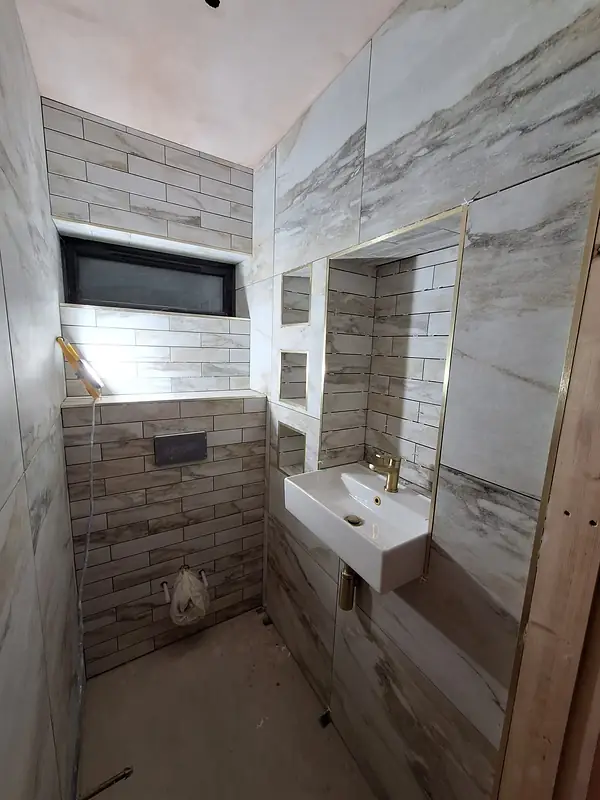 Marble effect shower room with a wall hung basin