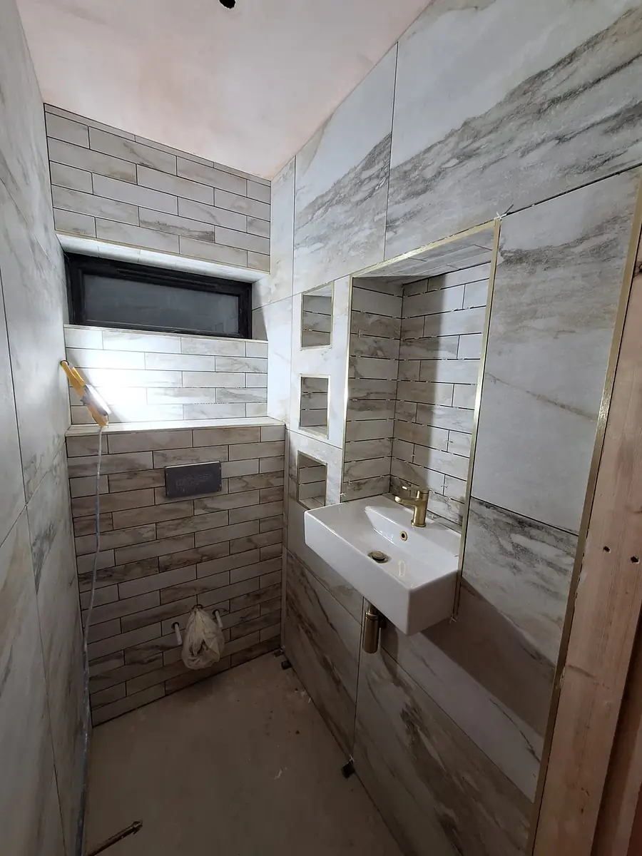 Marble effect shower room with a wall hung basin