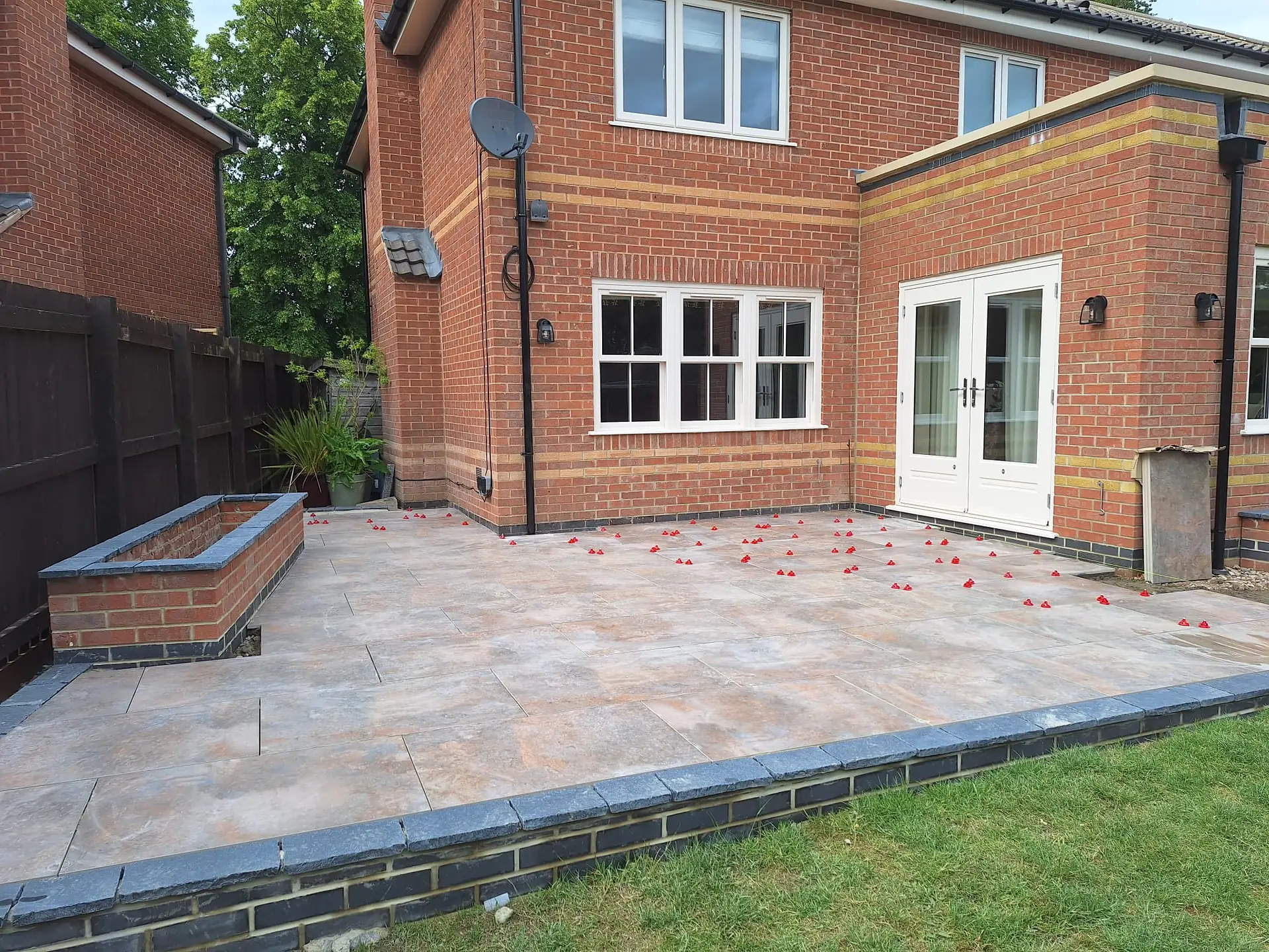 Natural stone patio behind a brick house