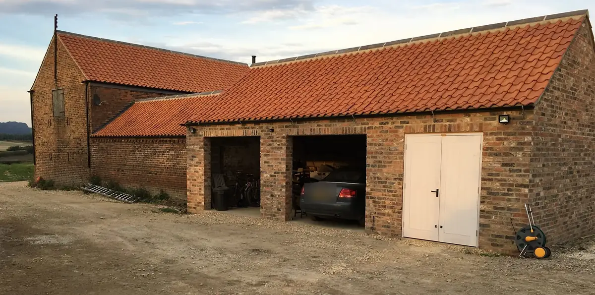 New brick and pantile barn buildings with garage bays