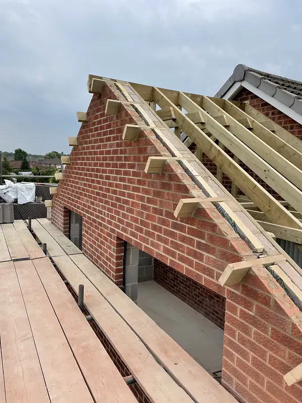 New roof trusses on a brick extension