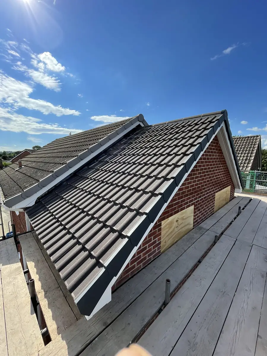 New tiled roof going on over a brick extension