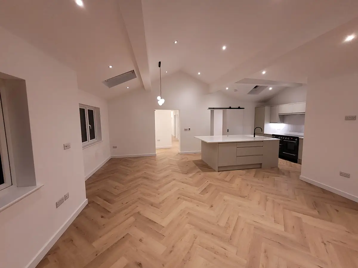 Open plan kitchen with herringbone floor
