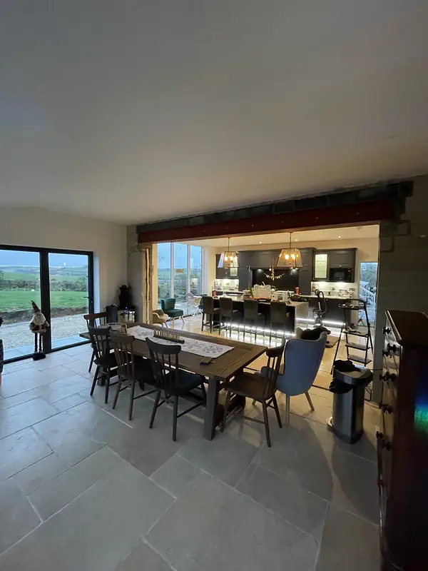 Open plan room with an oak floor and garden views