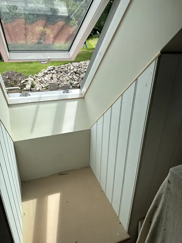 Panelled loft room under a rooflight