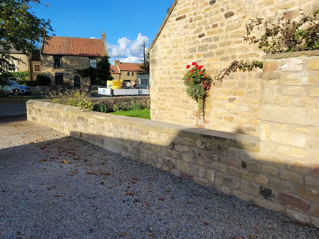 Stone boundary wall rebuilt and pointed in lime