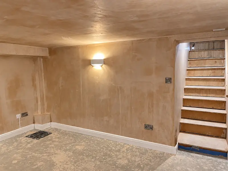 Plastered room with a timber staircase