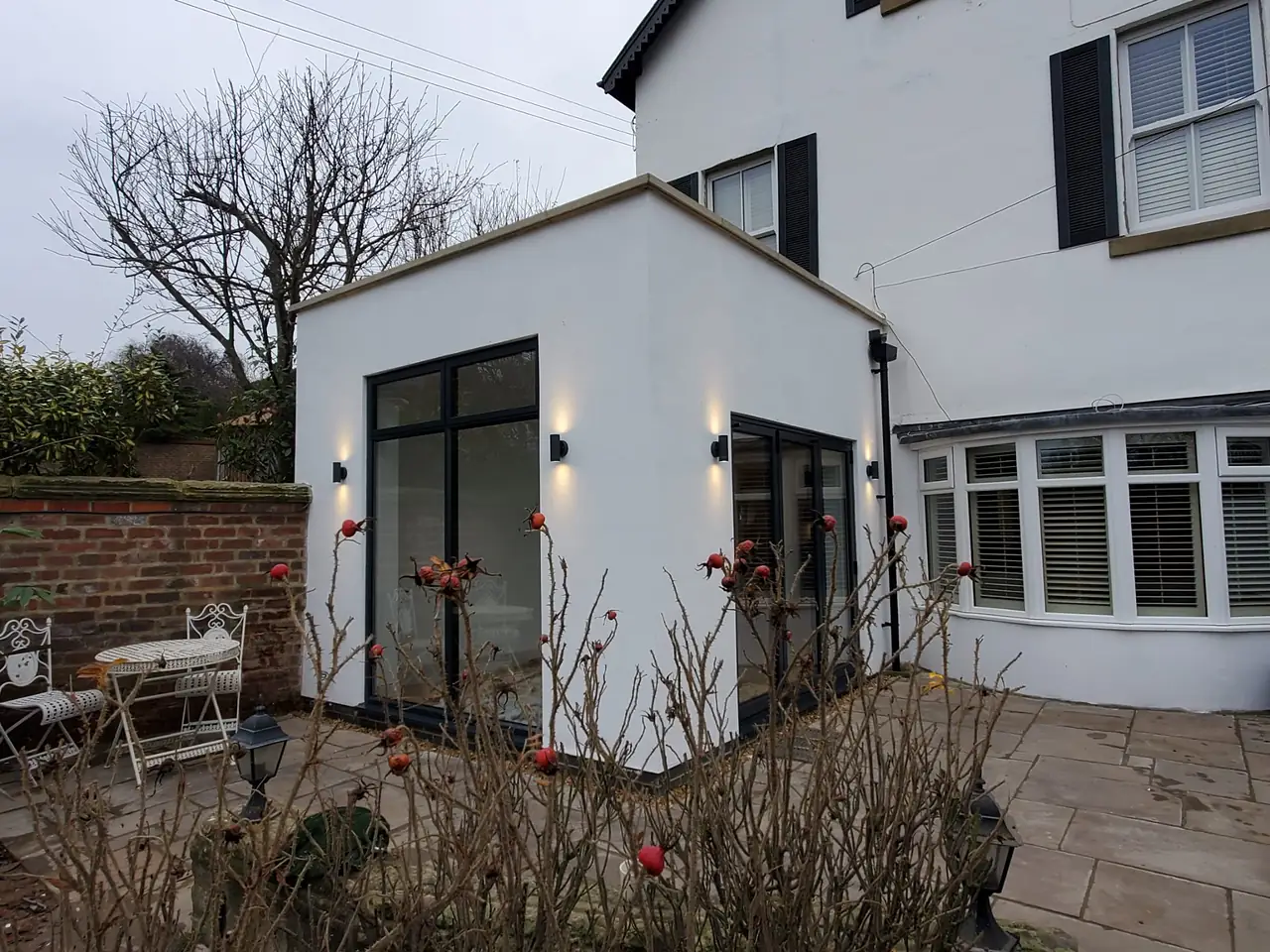 White rendered extension on a period house