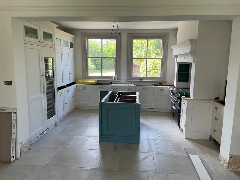 Renovated kitchen with a teal island