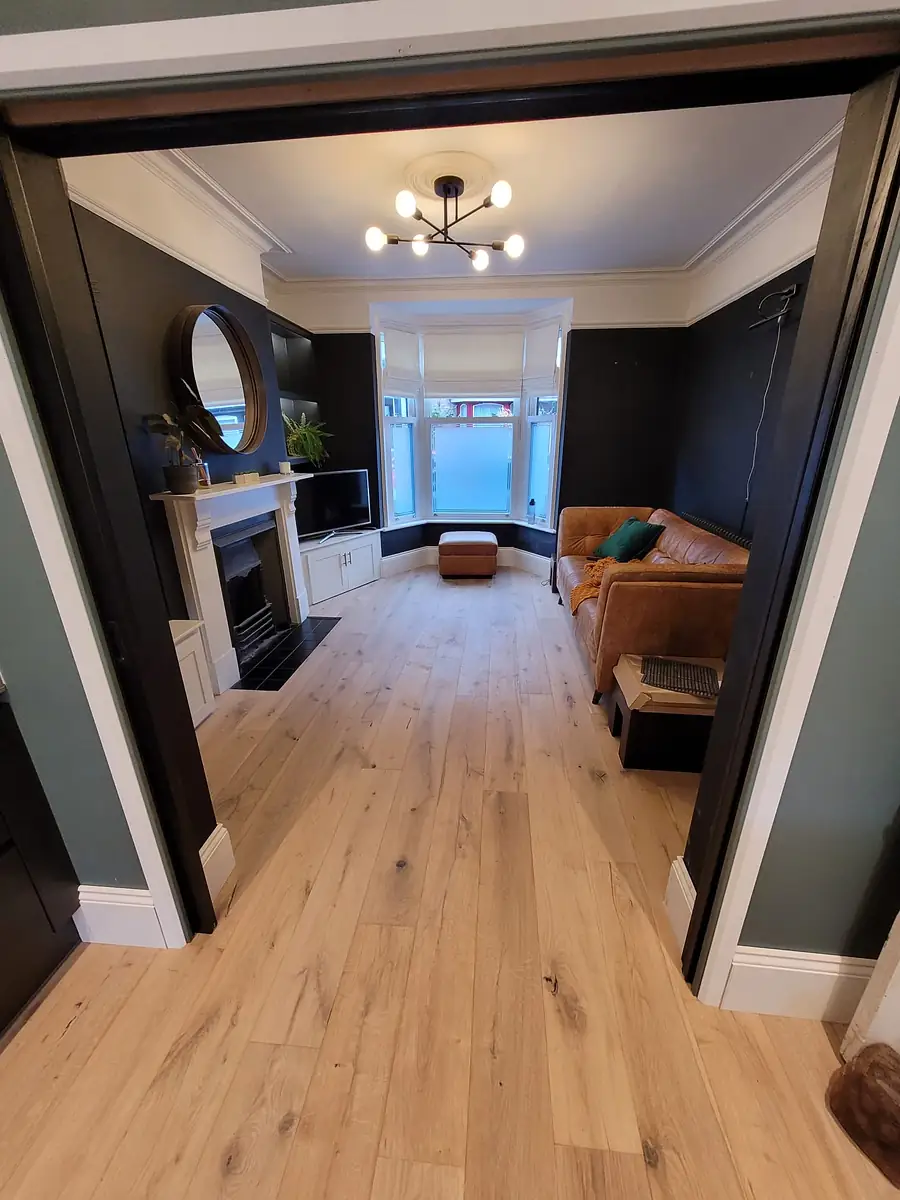 Renovated living room with an oak floor and a fireplace