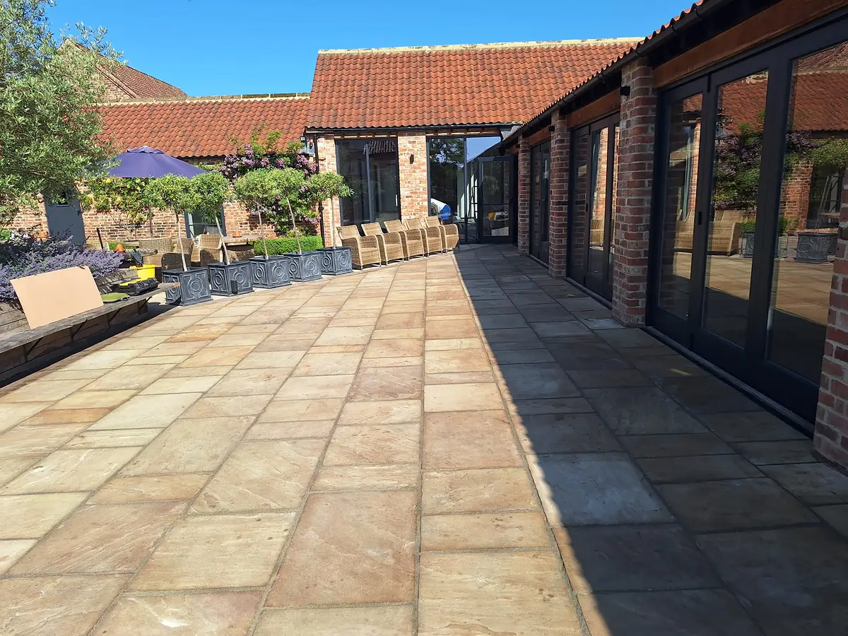 Sandstone courtyard beside converted barns