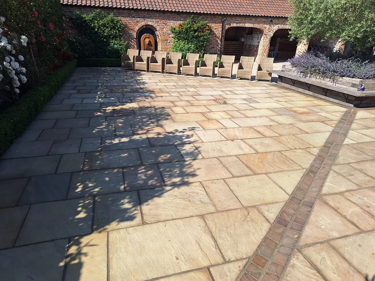 Sandstone patio laid in mixed sizes
