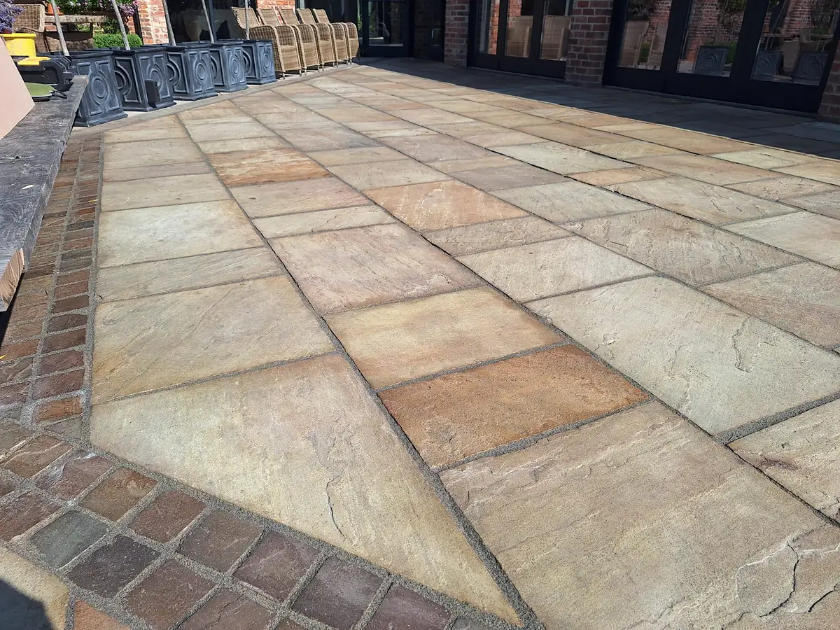 Sandstone patio with a brick edge