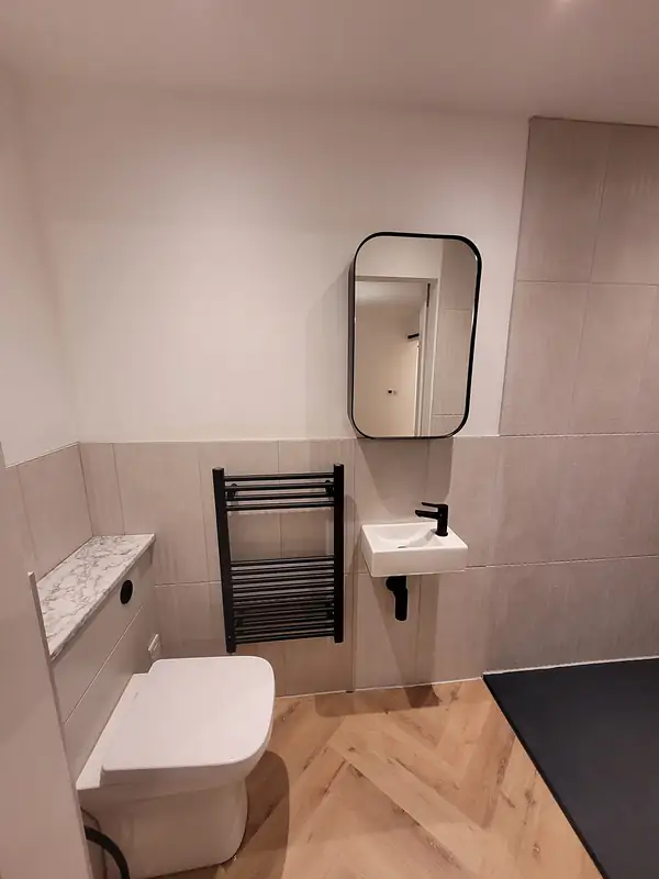 Shower room with a mirror and towel radiator