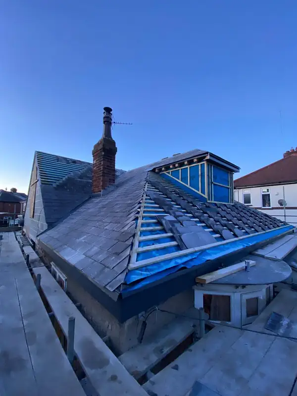 Slate roof being laid around new dormers
