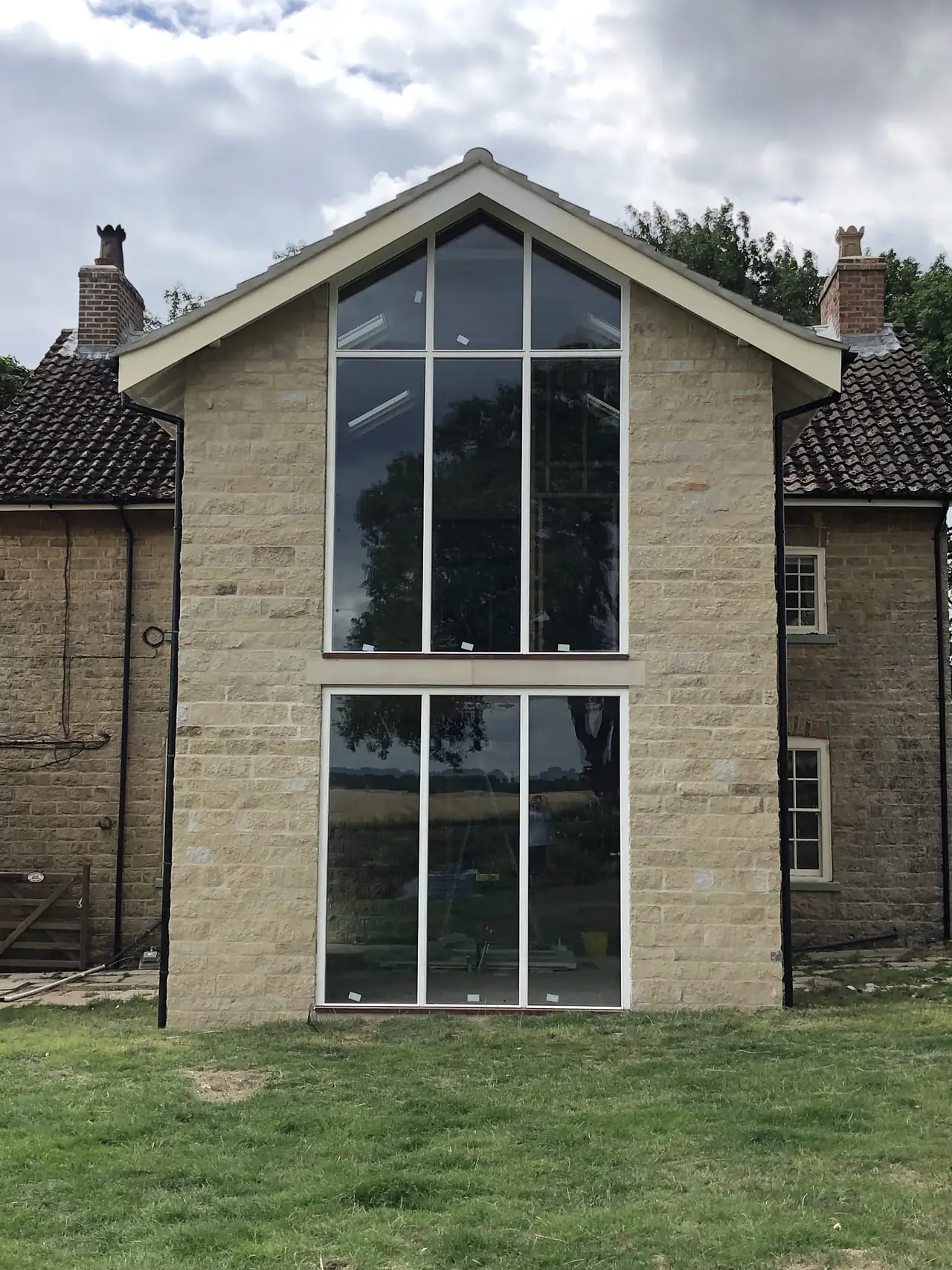 Stone extension with a full height glazed gable