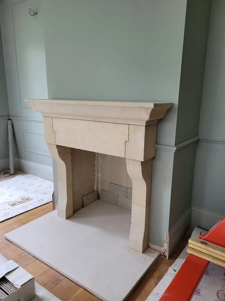 Stone fireplace surround in a painted room
