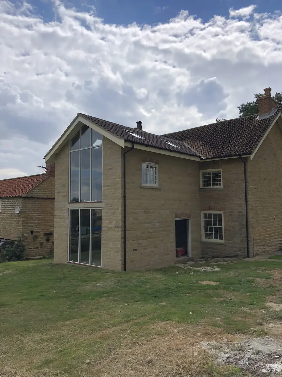 Stone house with a glazed gable extension