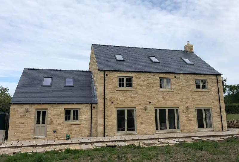 Stone house with rooflights in a new slate roof