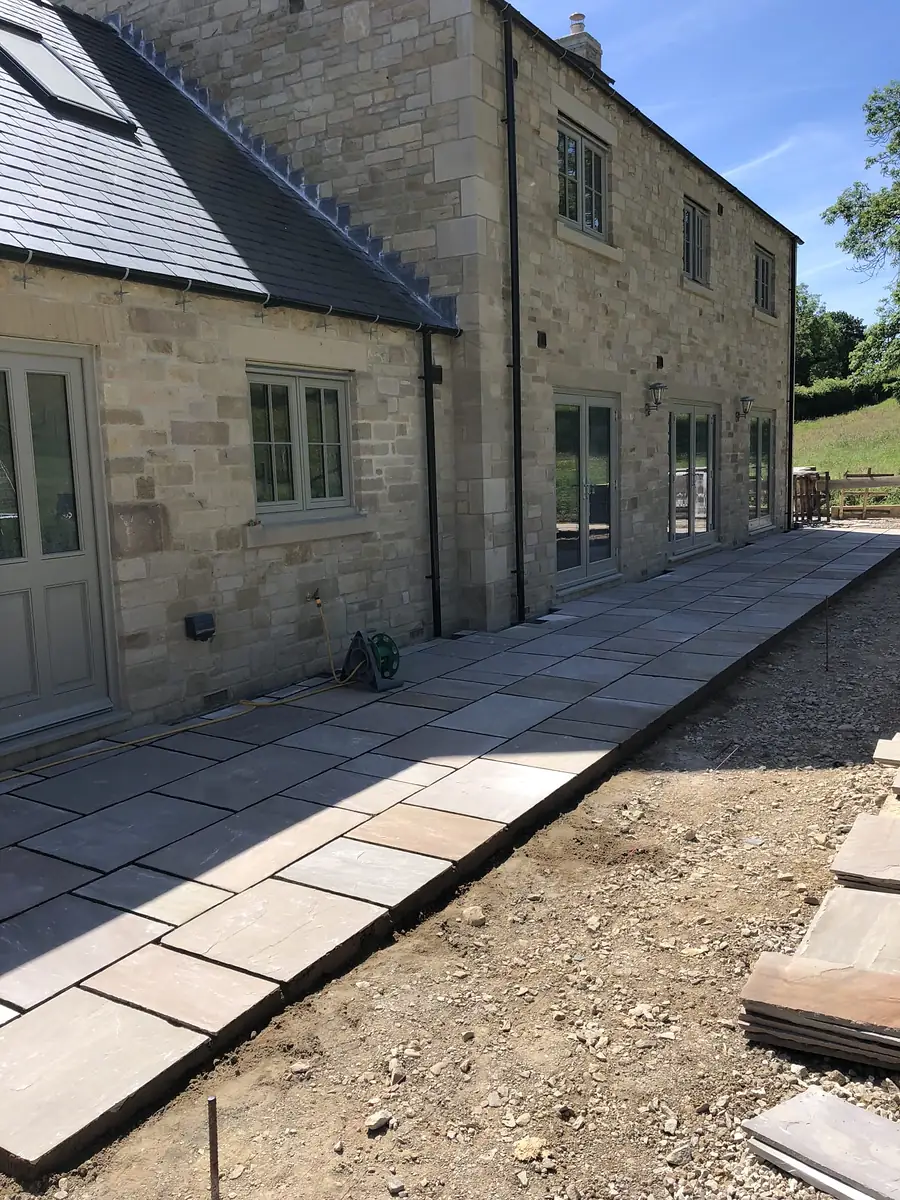 Stone new build with paving and planting