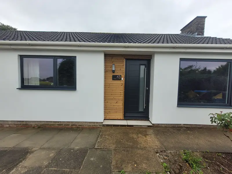 White rendered bungalow with a new front door