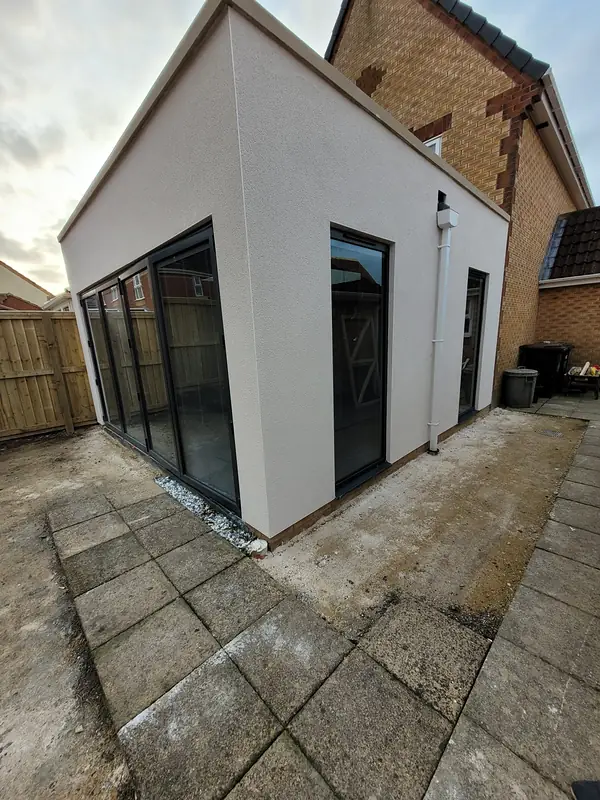 White rendered extension with full height glazing