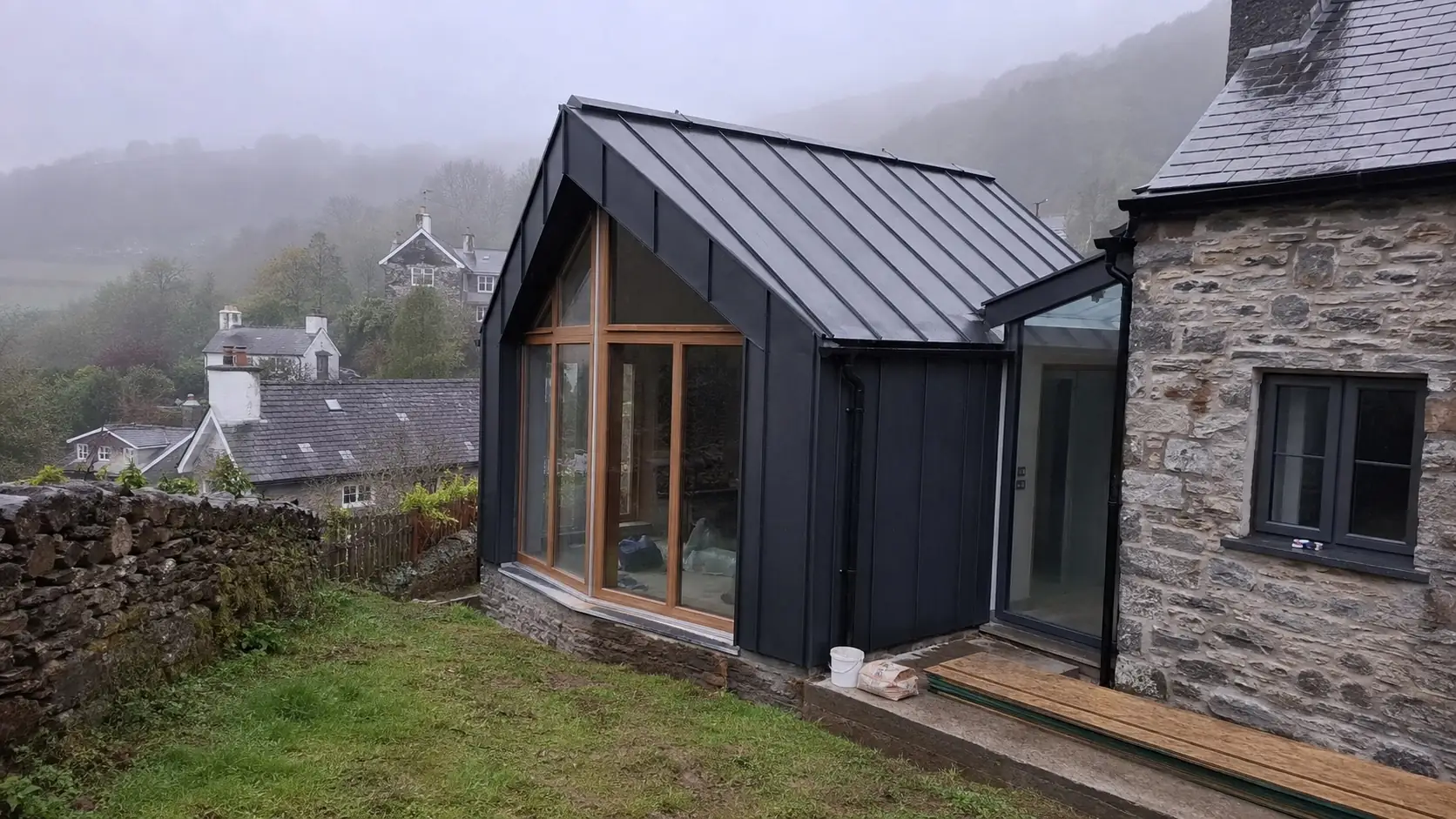 Zinc clad extension on a stone house